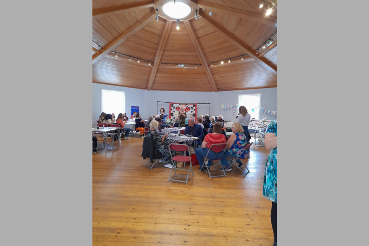 Members of the Forget me Nots gathered and talking at event Members of the Forget me Nots gathered and talking at event