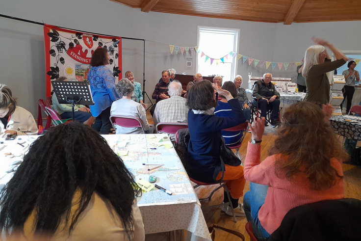 Members of the Forget me Nots gathered and talking at event Members of the Forget me Nots gathered and talking at event