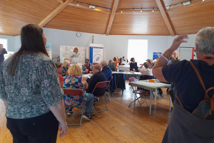 Members of the Forget me Nots gathered and talking at event Members of the Forget me Nots gathered and talking at event